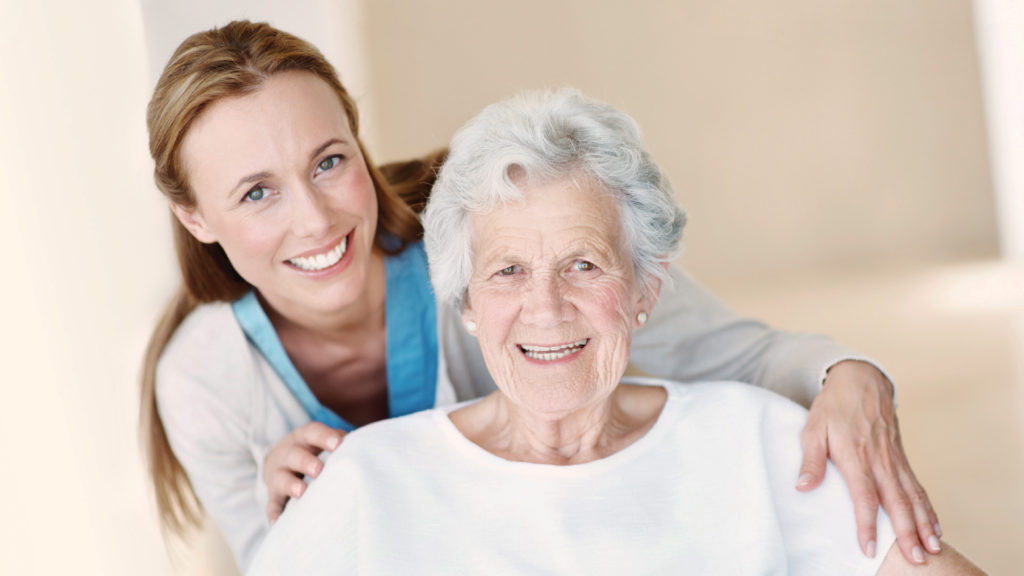 Nurse smiling with elderly woman