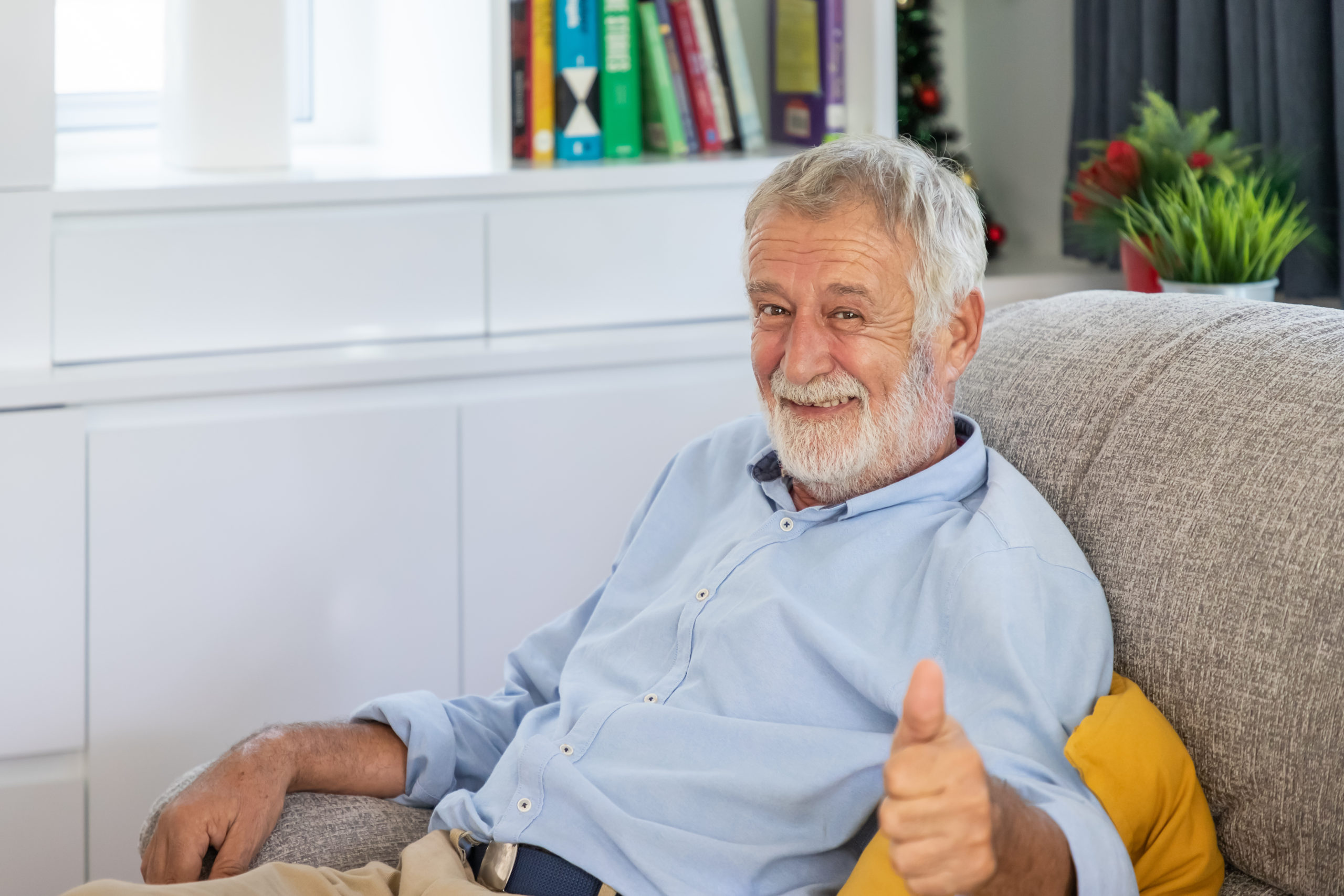 Relax happy senior old man eldery sitting on comfortable sofa in